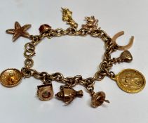 A 9ct gold circular link charm bracelet with circular clip fastening mounted with eleven charms