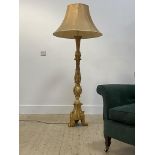 A late 20th century gilt composition standard lamp in the Rococo taste in the form of a candlestick,