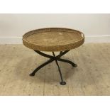 A large wicker twin handled circular tray table, on a wrought iron cross section base D80cm