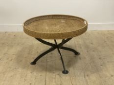 A large wicker twin handled circular tray table, on a wrought iron cross section base D80cm