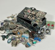 A Koha Abalone shell mounted box containing a large collection of shell mounted white metal and