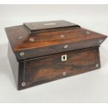 A Victorian rosewood mother of pearl inlaid sarcophagus shaped work box, the hinged to enclosing a