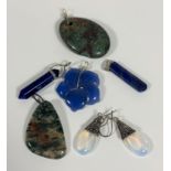 A collection of pendants and earrings including, a pair of moonstone pear shaped white metal drop