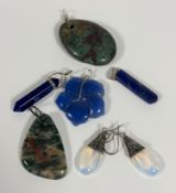 A collection of pendants and earrings including, a pair of moonstone pear shaped white metal drop
