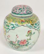 A late 19thc Chinese ginger jar and cover decorated in famille rose design with lotus panels