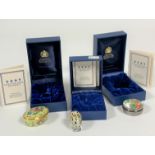 A collection of three Halcyon Days enamel pill boxes, an oval box of basket of fruit, (hx 2cm x l