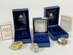 A collection of three Halcyon Days enamel pill boxes, an oval box of basket of fruit, (hx 2cm x l