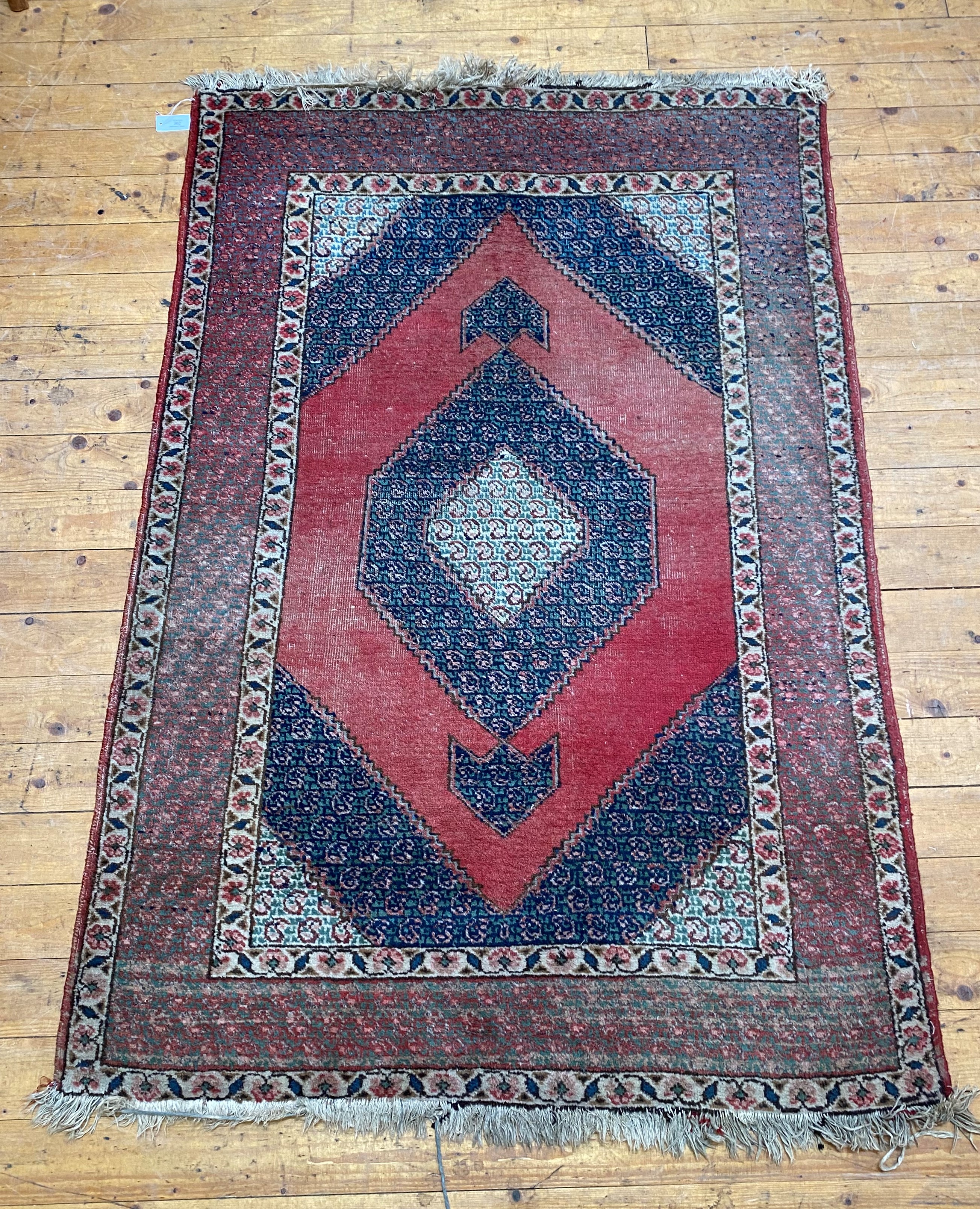 A hand knotted Persian Hamadan design rug, the lezenge medallion and conforming spandrels within