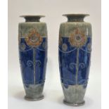 A pair of Royal Doulton vases with art nouveau tubed line stylized lotus flower decoration with