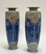 A pair of Royal Doulton vases with art nouveau tubed line stylized lotus flower decoration with
