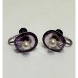 A pair of clam shell shaped amethyst stud earrings set seed pearl mounted on white metal screw