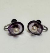 A pair of clam shell shaped amethyst stud earrings set seed pearl mounted on white metal screw