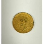 A yellow metal George V three pence piece. (d x 1.5cm) 2.765g heavy signs of use.