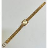 A lady's 9ct gold Gilmer of Bath wrist watch with square case and circular dial with baton hour