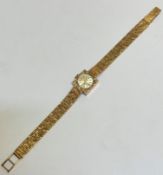 A lady's 9ct gold Gilmer of Bath wrist watch with square case and circular dial with baton hour