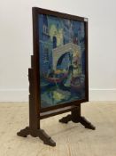 An early 20th century metamophic table / fire screen, with glazed needlework panel depicting a