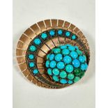 A Continental rose metal circular panel radiating brooch the centre set ten graduated turquoise