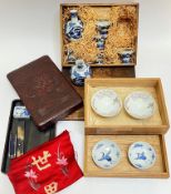 A mixed group of Japanese items including a blue and white porcelain sake set comprising two bottles