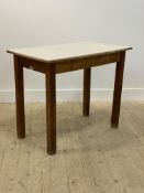 A mid century oak and beech kitchen table with formica top and single frieze drawer H74cm, W91cm