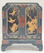 An early 20th century Japanese lacquered kodansu table cabinet, two two panelled doors decorated
