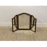 A 1930's walnut framed triptych vanity mirror of 18th century design, with undulating and moulded