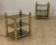 A pair of gilt brass three height end tables, each tier with smoked glass panels H61cm, W46cm,