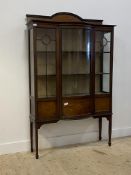 An Edwardian inlaid mahogany display cabinet, with ledge back over satinwood dentil frieze, two