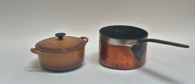 A brown Le Creuset cast-iron twin handled pot (w-26cm h-10cm) and a large copper saucer pan (l-42.