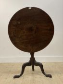 A George III mahogany snap top tripod table, the single plank circular top over baluster turned