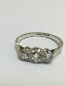 An 18ct white gold and platinum set three stone graduated diamond set ring, the centre brilliant cut