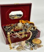 A jewellery box containing a collection of costume jewellery including a gilt metal hinged bangle,