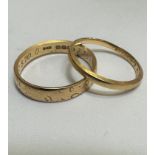 A 18ct gold wedding band with engraved border and internal inscription, size N and a yellow metal