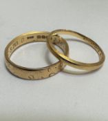 A 18ct gold wedding band with engraved border and internal inscription, size N and a yellow metal