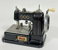 A Vulcan tinplate child's toy 1930-50's model table top sewing machine, some losses to black