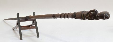 A Chokwe, Angola, carved wooden staff, with crouching figural terminal over a shaft carved in relief