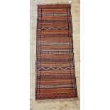 A flat weave runner rug of geometric and lineal design 196cm x 70cm