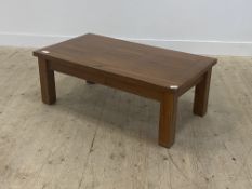 A varnished pine low table, with panelled top raised on square section supports H40cm, L60cm x