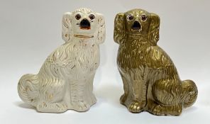 A pair of Staffordshire pottery Wally dogs, one glazed in white with glass eyes, the other