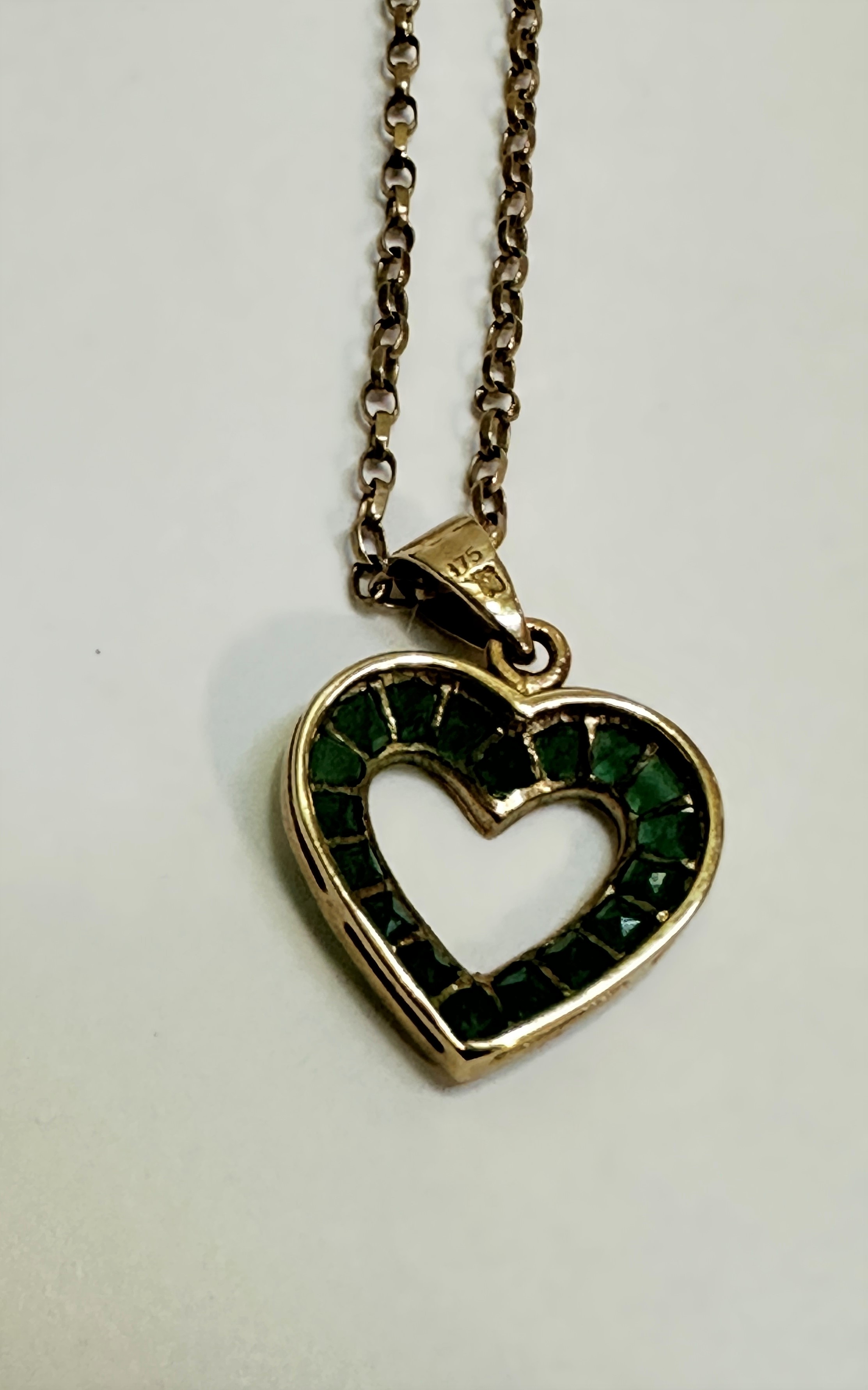 A 9ct gold open work heart shaped pendant set eighteen calibre set emeralds mounted on trace link - Image 3 of 3