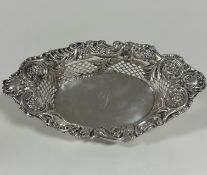 An Edwardian Chester silver navette shaped scalloped fruit basket with rococo C scroll, floral and
