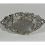 An Edwardian Chester silver navette shaped scalloped fruit basket with rococo C scroll, floral and