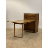 An unusual mid 20th century oak veneered folding cabinet desk, the modular two drawer chest over a