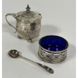 A Victorian Birmingham silver half spiral lobed drum mustard with urn finial raised on four ball