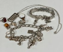 A collection of silver jewellery including an oval spiral link charm bracelet with thirteen