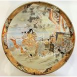 A large Kutani porcelain charger with enamelled decoration depicting boats and a goshoguruma scene