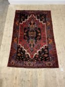A Persian hand knotted Hamadan design rug, the dark abrashed field with stylised foliate and