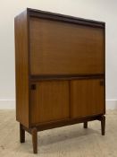 Beaver and Tapley, a mid century teak bureau, the fall front opening to a fitted interior, over twin
