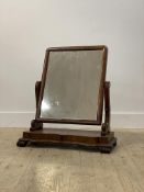 A mid 19th century mahogany vanity mirror, the original mirror plate swiveling between two