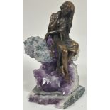 A Ebano International resin bronze plated sculpture Vidal of a seated figure seated on a amethyst