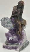 A Ebano International resin bronze plated sculpture Vidal of a seated figure seated on a amethyst
